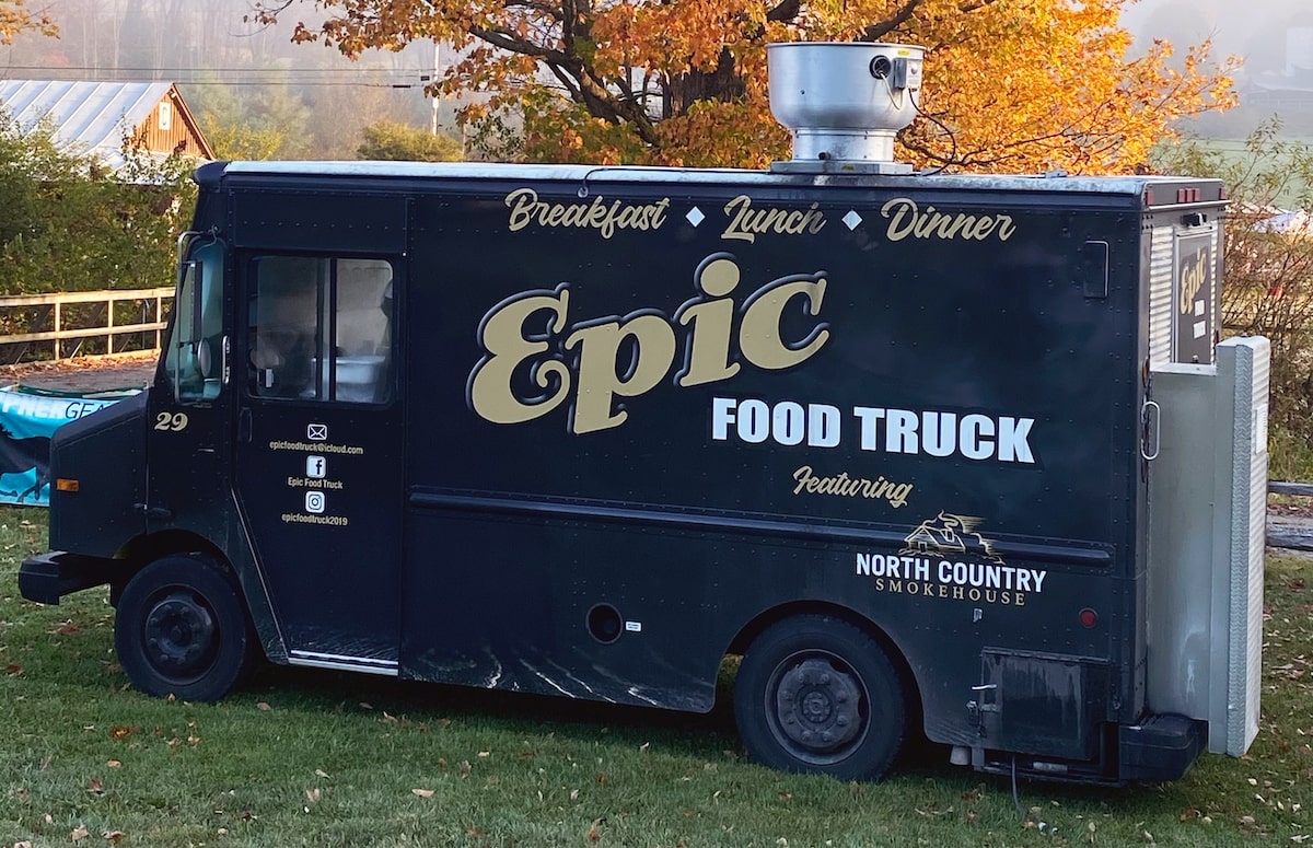 The Epic Food Truck parked under a tree